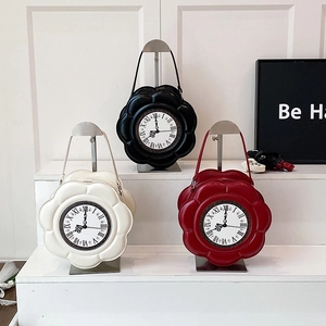 Unique flower shaped clock handbags in black, white and red colors on metal stands