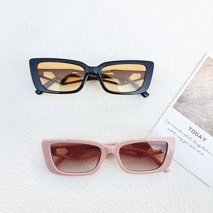 Detailed macro view of retro rectangle sunglasses with hollow temples in pink and black