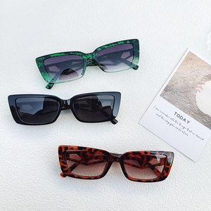 Close-up of retro rectangular sunglasses in green marble, black, and leopard patterns