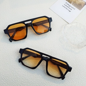 Detail of punk style thick frames with orange and yellow gradient lenses for sunglasses