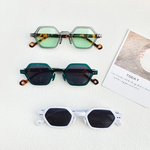 Chic irregular hexagonal sunglasses with glossy frames in multiple colors on white background