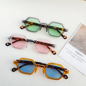 Three colors of retro hexagonal sunglasses with tortoiseshell temples in a flat lay view