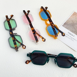 Detailed flat lay of geometric hexagonal sunglasses in four assorted trendy colors