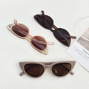 Chic retro white cat eye sunglasses in dark coffee, amber, and beige tones displayed on a card