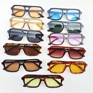 Flat lay of retro double-bridge pilot sunglasses in tortoiseshell and vibrant colors