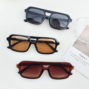 Vintage double-bridge aviator sunglasses in black and tortoiseshell finishes on white surface