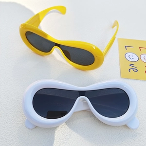 Detail view of colorful retro thick round sunglasses with smooth resin frame texture