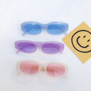 Three pairs of vintage oval cat eye sunglasses in blue, purple and pink candy colors