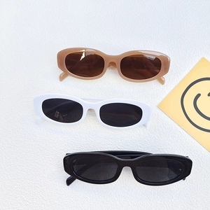 Retro oval candy-colored sunglasses in brown, white, and black for fashion street style