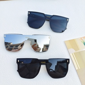 Flat lay of oversized square sunglasses in navy blue, transparent, and classic black frames