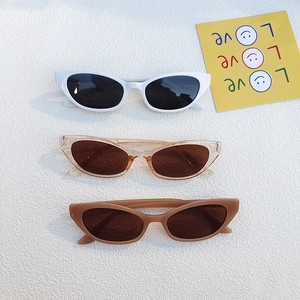 Three pairs of vintage cat eye sunglasses in various colors on a stylish background