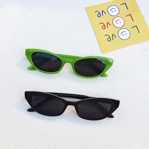 Vintage cat eye sunglasses in black and lime green frames with dark lenses