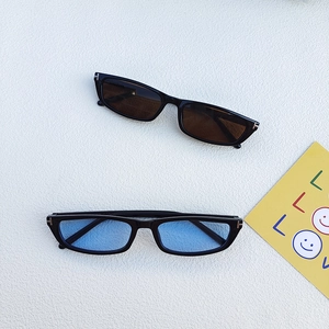 Narrow rectangular fashion sunglasses with black frames and metallic T-shaped accents