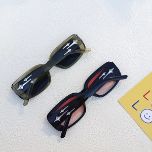 Detail of rectangular sunglasses featuring silver star ornaments on the temples