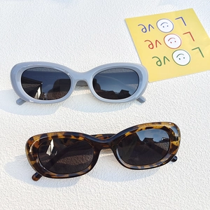 Retro cat-eye sunglasses with oval blue and tortoiseshell frames and dark grey lenses