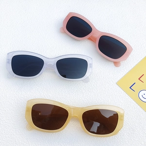 Three pairs of vintage rectangular cat-eye sunglasses in pink, grey, and amber frames