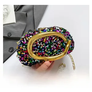 Close-up of colorful sequin evening bag with a large gold metal handle and chain strap