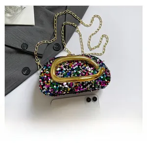 Close-up of colorful sequin evening bag with gold D-handle and metal chain strap