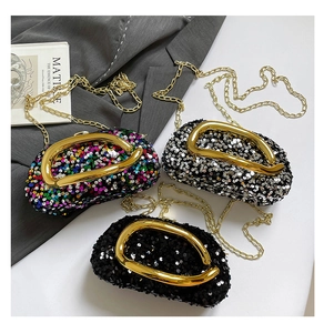 Detailed view of sequin evening bags in silver, black and multi-color with gold U-handles