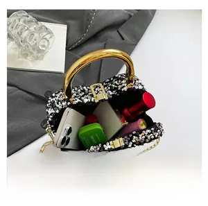 Detail view showing interior capacity of sequined bag with phone and cosmetics
