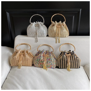Macro shot of rhinestone bucket bags with crystal fringe and round metal handles