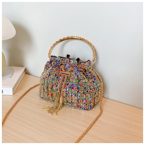 Detail of colorful rhinestone bucket bag with gold chain strap and tassel drawstring