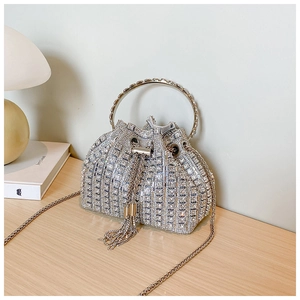 Detail of silver rhinestone bucket bag with tassel drawstring and metal ring handle