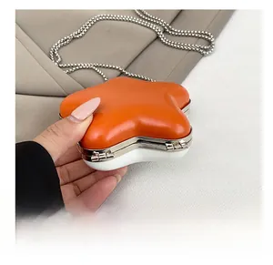 Detail view of the star-shaped mini lipstick bag showing its durable bottom and chain