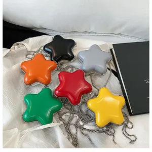 Detailed view of colorful star-shaped mini bags in six bright glossy faux leather finishes