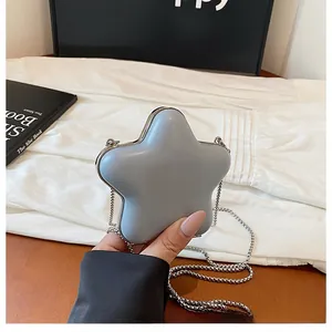 Detailed view of a star-shaped mini crossbody bag with silver chain and metal frame