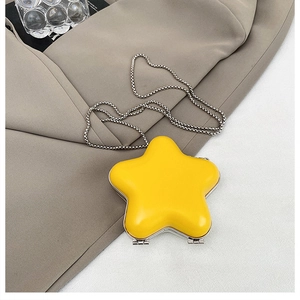 Detail of yellow star-shaped mini lipstick bag with silver metal chain and smooth finish