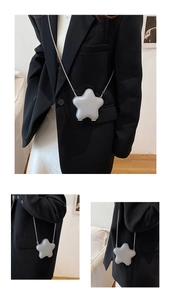 Detail view of the star-shaped mini crossbody bag with metal chain and matte gray finish