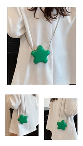 Detail view of mini star-shaped crossbody bag with glossy green finish and silver chain