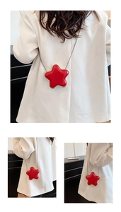 Star-shaped mini crossbody bag with glossy red finish and silver chain strap details