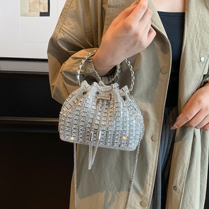 Sparkling rhinestone bucket bag with silver ring handle and tassel drawstring detail