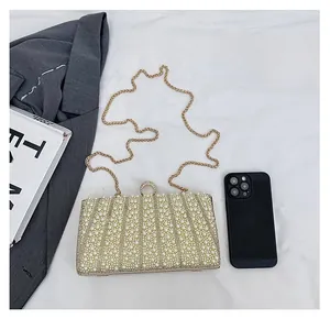 Detailaufnahme der Perlen-Abendtasche mit goldener Strass-Schließe und eleganter Kette