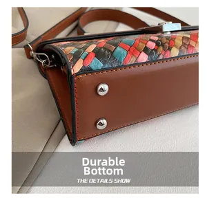 Close-up of the wear-resistant leather base with metal studs on a multi-color woven tote bag
