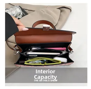 Detail showing the internal capacity and black lining of the brown woven leather bag