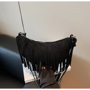 Chic black suede crescent bag with fringe tassels and a slim shoulder strap