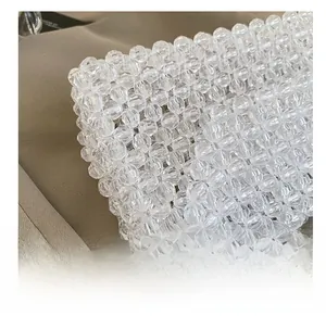 Close-up detail of hand-woven acrylic crystal beaded bag with faceted beads and exquisite texture