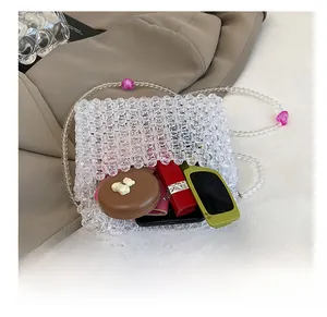 Internal capacity of acrylic beaded bag showing lipstick, sunglasses and smartphone