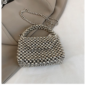 Detailed view of silver acrylic beaded handbag with a metallic finish and crossbody chain