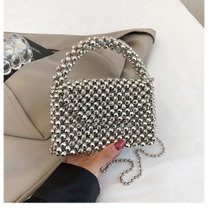 Detail of silver beaded mini handbag showing intricate woven texture and metal chain strap