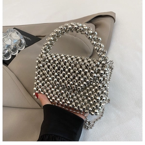 Close-up of a silver acrylic beaded mini bag with faceted beads and chain strap