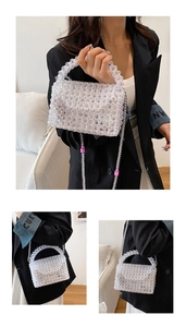 Detailed view of hand-woven acrylic beaded clear bag with pink accents and pearl straps