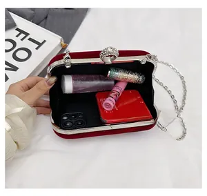 Interior view of burgundy velvet clutch showing capacity for phone and cosmetics