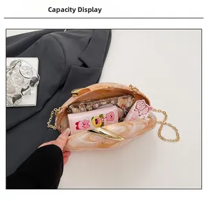 Internal view of acrylic marble evening bag showing capacity for phone and wallet