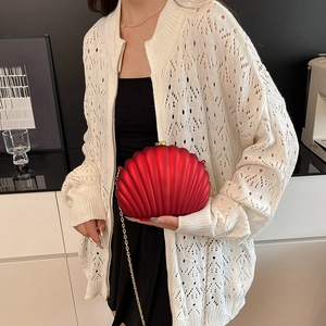Elegant red shell-shaped acrylic evening clutch with gold chain and ribbed texture
