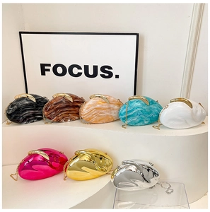 Collection of irregular marble-textured acrylic evening bags with gold chain straps