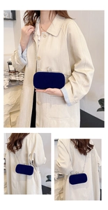 Detail of blue velvet evening bag with silver chain strap and crystal ring clasp